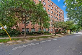 Baltimore apartment for rent - an empty street in front of a tall brick building