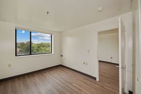 Baltimore apartment for rent - an empty living room with wood floors and a large window