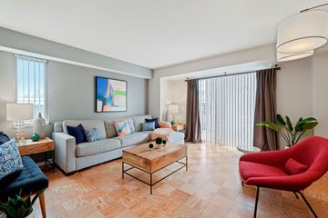Washington apartment for rent - A living room with a red chair and a grey couch.