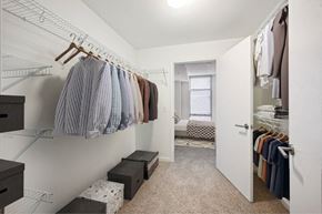 Silver Spring apartment for rent - a walk in closet with clothes hanging on a rack