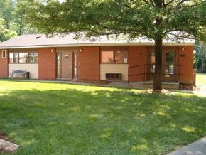Warfield apartment for rent - a small brick house with a tree in the yard