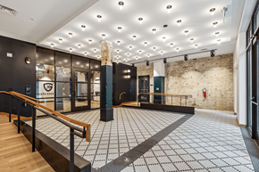 Baltimore apartment for rent - the lobby of a building with a staircase and glass doors