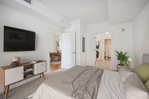 Silver Spring apartment for rent - a bedroom with a large bed and a tv on the wall