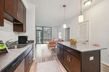 Silver Spring apartment for rent - an open kitchen with a large island and a living room with a couch