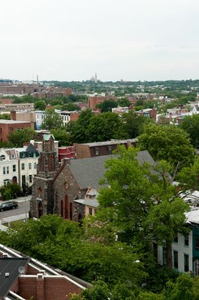Washington apartment for rent - A cityscape with a church in the foreground and a domed building in the distance.