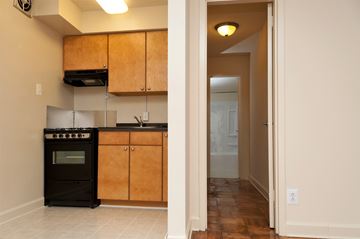 Washington apartment for rent - A kitchen with wooden cabinets and a black oven.