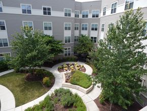 Washington apartment for rent - A courtyard with a circular garden and a building in the background.