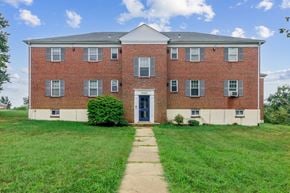 Baltimore apartment for rent - an old brick building with a sidewalk in front of it