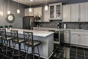 Omaha apartment for rent - a kitchen with a center island and three chairs