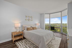Clayton apartment for rent - A bedroom with a large bed and a view of the outdoors through the window at Clayton on the Park Apartments, Missouri, 63105