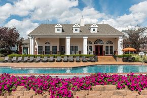 Ofallon apartment for rent - A white house with a pool in front of it.