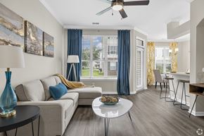 Ofallon apartment for rent - A living room with a couch, a table, and a ceiling fan.