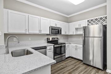Ofallon apartment for rent - A kitchen with white cabinets and stainless steel appliances.