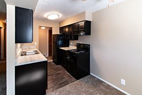 Omaha apartment for rent - a kitchen with black appliances and a counter top