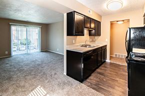 Omaha apartment for rent - a kitchen and living room with a sliding glass door