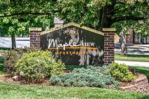 Omaha apartment for rent - a sign for magic view apartments in front of a tree