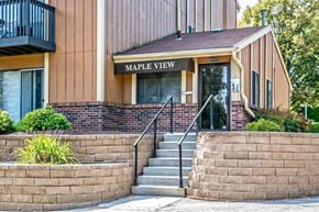 Omaha apartment for rent - a building with stairs and a sign that reads maple view