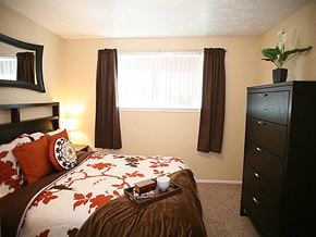 Omaha apartment for rent - a bedroom with a bed and a dresser