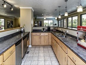 Omaha apartment for rent - a large kitchen with wooden cabinets and a sink