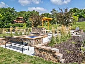Omaha apartment for rent - a backyard with benches and a patio with a hot pool