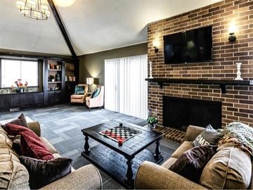Omaha apartment for rent - a living room with a couch and a coffee table and a fireplace