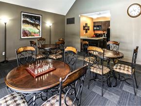 Omaha apartment for rent - a game room with tables and chairs and a chess board