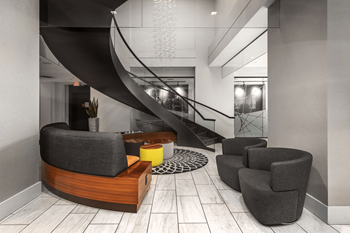 A modern living room with a curved sofa, armchairs, and a staircase.