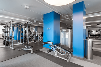 A gym with a variety of equipment including a leg press machine.