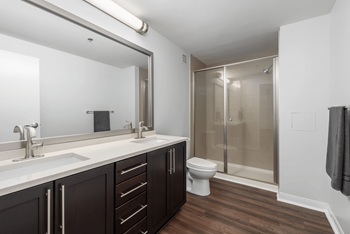 A bathroom with a toilet, sink, and shower.