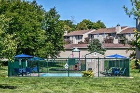 Omaha apartment for rent - a yard with a playground and a house in the background
