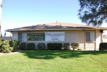 Riverside apartment for rent - A house with a sign that says "Bogart Apartments Now Renting!".