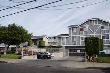 Hawthorne apartment for rent - A black car is parked in front of a white building.