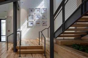Cleveland apartment for rent - A staircase with a black railing and wooden steps.