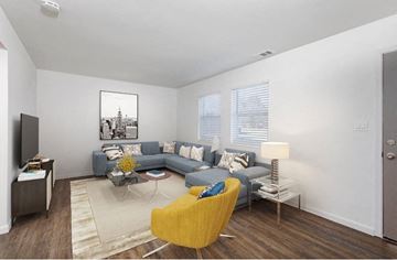 Evansville townhouse for rent - A living room with a grey couch, a yellow chair and a painting on the wall.