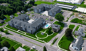 Portland apartment for rent - An aerial view of a large building with a pool in the middle of a grassy area.