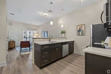 Portland apartment for rent - A kitchen with a white counter top and dark wood cabinets.