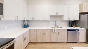 Albuquerque apartment for rent - A kitchen with white cabinets and a wooden floor.