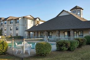 Conway apartment for rent - A large building with a pool in front of it.