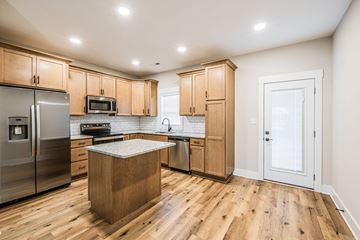 Bowling Green apartment for rent - A kitchen with wooden cabinets and a wooden island.