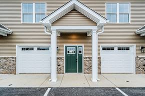 Bowling Green apartment for rent - A house with a green door and white garage doors.