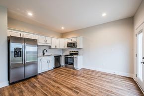 Bowling Green apartment for rent - A kitchen with a refrigerator, microwave, oven, and cabinets.