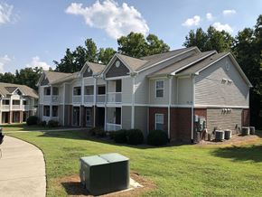 Oxford apartment for rent - an apartment building with a green lawn and a trash can