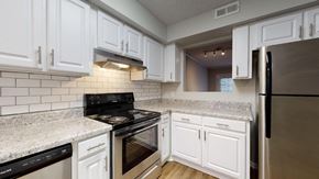Oxford apartment for rent - a kitchen with white cabinets and stainless steel appliances