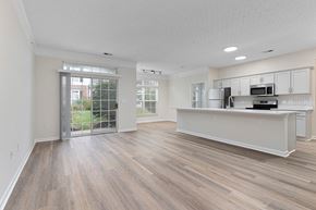 Columbus apartment for rent - an open living room and kitchen with a door to a patio  at The Charleston, Columbus