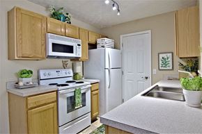 Pataskala apartment for rent - A kitchen with wooden cabinets and a white refrigerator.