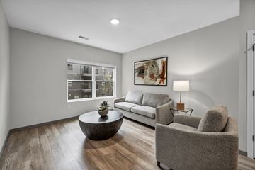 Columbus apartment for rent - A living room with a grey couch, a grey armchair, a coffee table, and a painting on the wall.