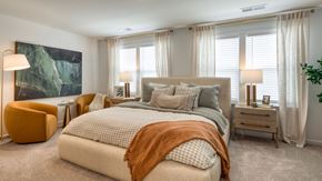 Harrisonburg townhouse for rent - A bedroom with a large bed and a painting on the wall at The Mark Townhomes Apartments, Harrisonburg, VA