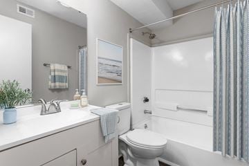Greensboro apartment for rent - A bathroom with a white toilet and a white sink.