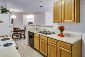 Henrico apartment for rent - A kitchen with wooden cabinets and a white countertop.