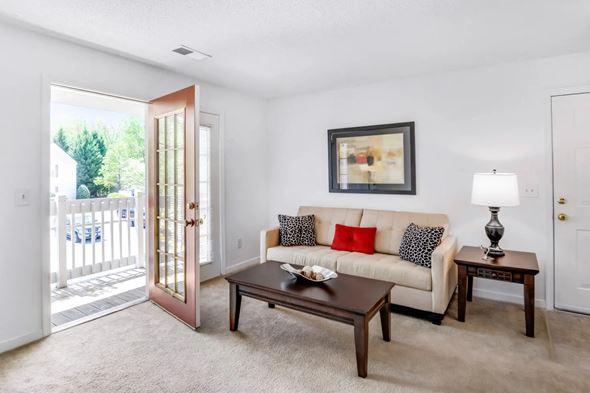 Henrico apartment for rent - A living room with a white couch and a coffee table.
